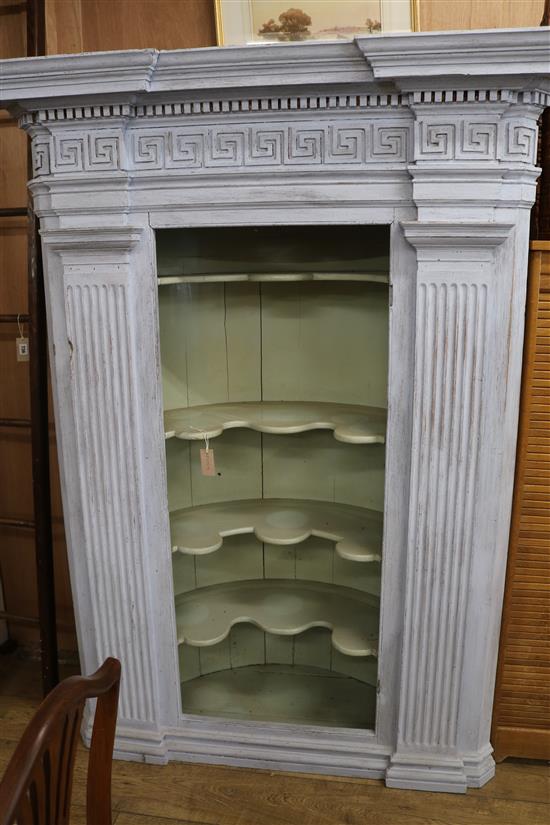 An architectural painted corner cupboard W.137cm